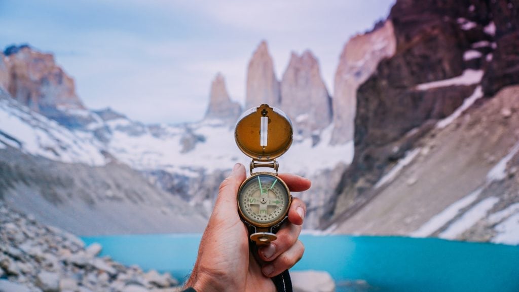 Compass and hands with a mountain in the background promoting the SEO Page Inventory